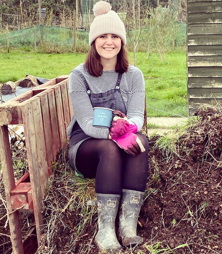 Shannon portant des gants de jardinage rose vif sur un allotissement
